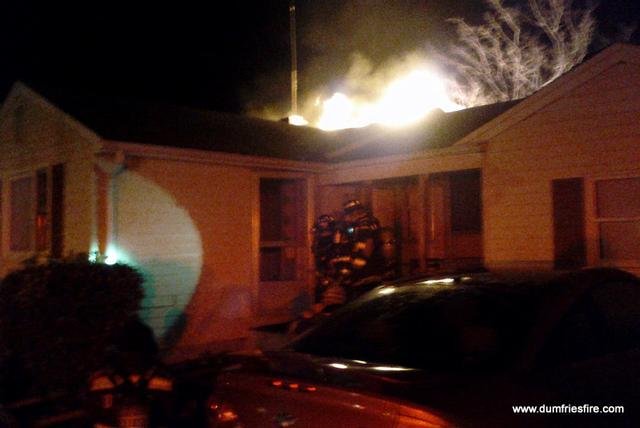 Dumfries-Triangle firefighters working a structure fire at night